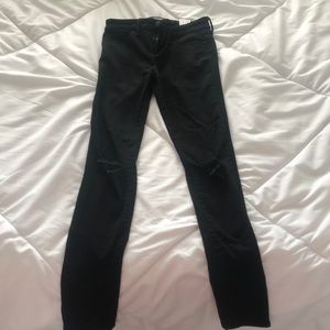 Black jeans with rips in the knees